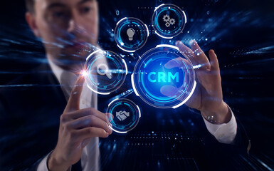 Business, Technology, Internet and network concept. Young businessman working on a virtual screen of the future and sees the inscription: CRM