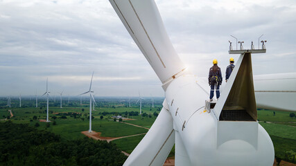 
Inspection engineers standing on top of a wind turbine for Background Image.