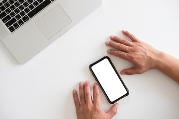 man sitting useing smartphone  and makes online shopping in a white room