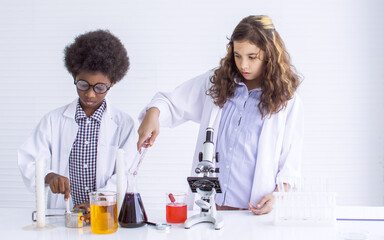 Girl and boy studying science at school