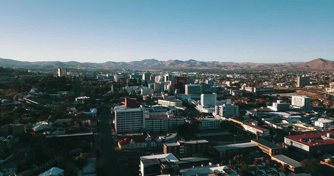 4K sunrise aerial footage of savanna hills, Windhoek central business district, residential suburb, mountains around city in Namibia's capital in central highland of Namibia, southern Africa