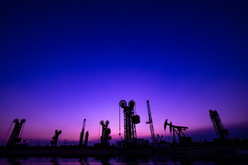 Fototapeta na wymiar Oil pumping machinery in operation, crude oil extraction scene in the night, North China