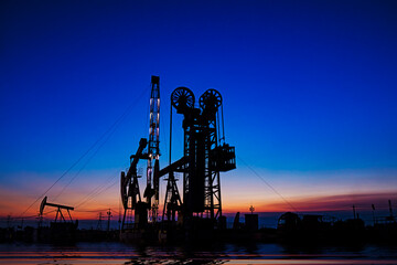 Oil pumping machinery in operation, crude oil extraction scene in the night, North China