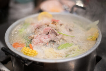 Thai barbecue Grill Pork on hot pan. Barbecue buffet pig pan and vegetables in soup.