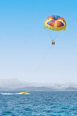  Colorful parasail wing pulled by a boat. Water fun activities.