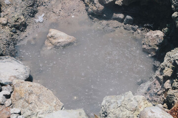 Sikidang crater with the background of sulfur vapor coming out of the sulfur marsh.
