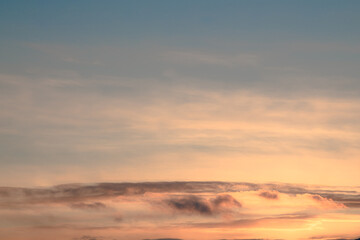 Sunset sky replacement for photoshop, lightroom edit. Pink, pastel tones fading into blue above wispy, flat clouds. 