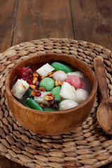 Fototapeta na wymiar Wedang Sekoteng. Traditional Javanese warm dessert of glutinous rice ball, sago pearls, toddy palm fruit, bread cubes and peanuts in fragrant ginger soup.