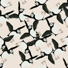 Hand drawn creative seamless pattern with random abstract puffin birds shapes. Light pink background.