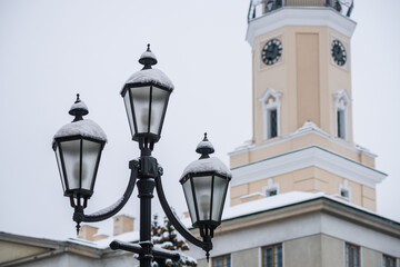 DROHOBYCH, UKRAINE - FEBRUARY 10, 2021: Street lantern on the background of the Drohobych City Hall.