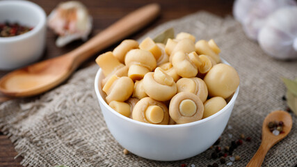 Pickled mushrooms - champignons in a bowl. Food preserving.