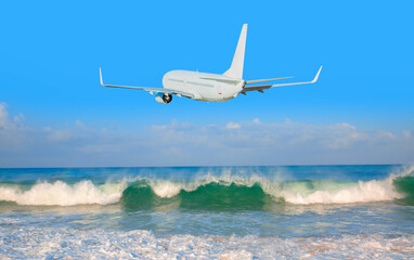 Fototapeta na wymiar White passenger airplane flying away in to sky high altitude during bright blue sky
