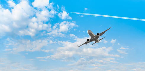 White passenger airplane over the clouds  - Travel by air transport