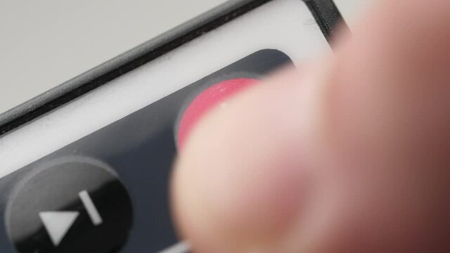 Pressing the power button on the remote control close-up shot
