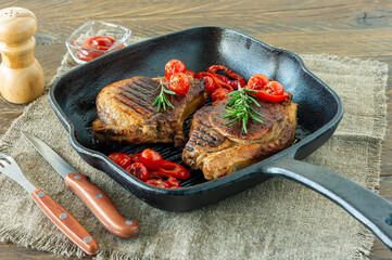 Fresh juicy roasted red meat on grill pen, with spices and vegetables. Restaurant food, delicious dish