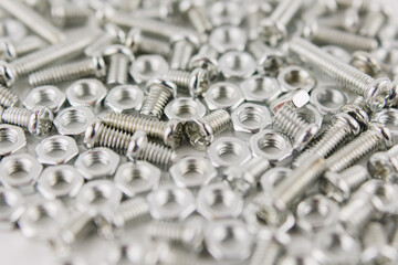 iron screws and nuts on a white background for repair close up