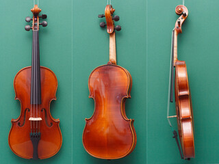 Antique fine violin from front, back and side on green background
