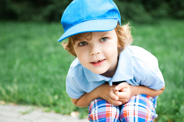 Portrait of cute preschooler boy in blue cap.