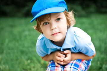 Portrait of cute preschooler boy in blue cap.