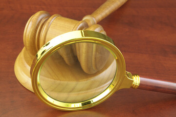 Court and justice review concept. Magnifying glass and judge gavel on table.	