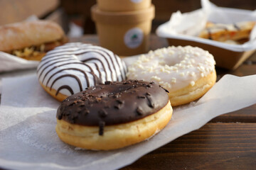 Street food and coffee on a wooden table in the street in winter