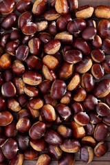 Pile of edible sweet chestnuts (Castanea sativa), food background