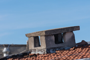 Naklejka premium old concrete chimney on the roof, ruined air duct,