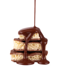 Porous chocolate pieces and chocolate syrup, isolated on white background. White aerated chocolate.