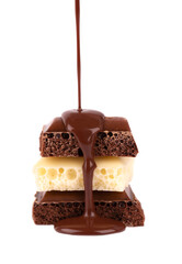 Porous chocolate pieces and chocolate syrup, isolated on white background. Black and white aerated chocolate.