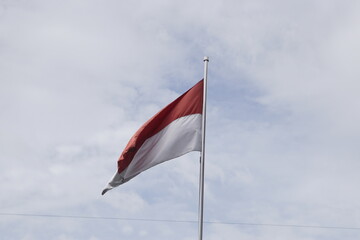 Indonesia flag on blue sky : raising the Indonesian flag on Indonesian Independence Day. Instill a sense of Indonesian nationalism