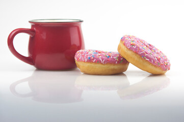 Tasty donut with a cup of coffee on white background