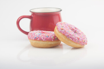 Tasty donut with a cup of coffee on white background
