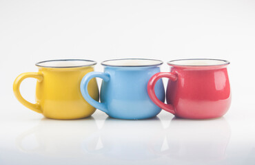 Set colorful ceramics cups on white background