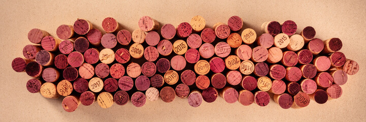 Wine corks panorama on a brown background, overhead shot