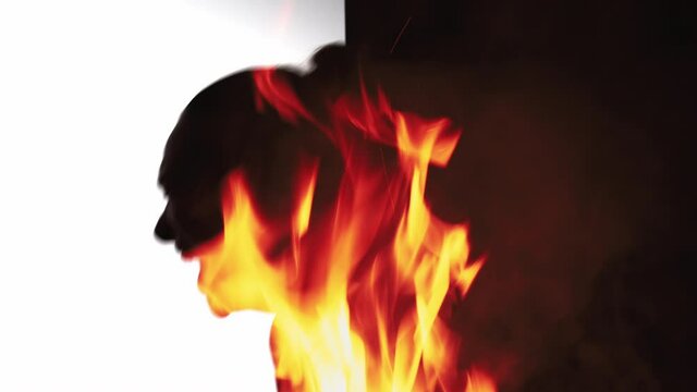 Double exposure silhouette. Nervous breakdown. Anger hate. Emotional crisis. Fire flame smoke animation in dark profile outline of frustrated fierce woman yelling isolated on white black background.