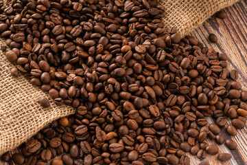 coffee background, coffee beans on burlap and wooden table