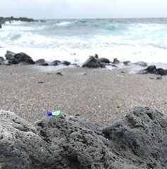 A beautiful view from the volcanic stone-filled beach in Moroni. A few colored sea glass stones...