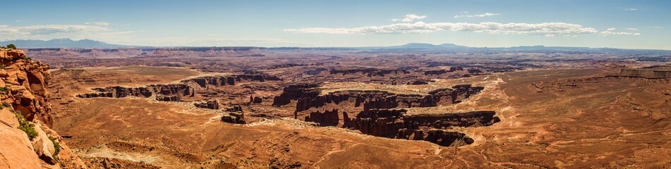 Fototapeta na wymiar Panorama shot of sandy red canyons in island in the sky at sunny day of part canyonland national park in Utah, america