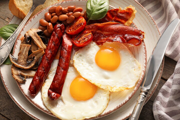 Traditional English breakfast with fried eggs on wooden background