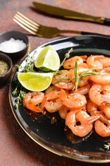 Plate with tasty shrimps on grunge background, closeup
