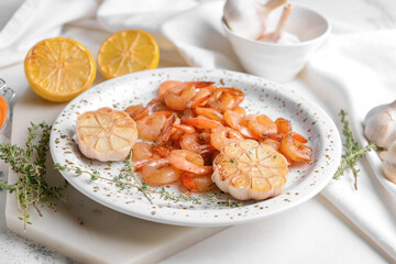 Plate with tasty shrimps on table