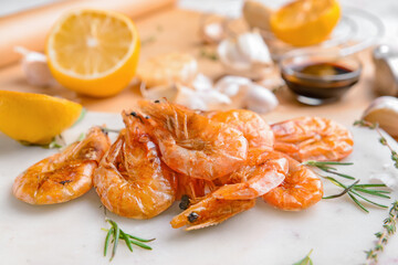 Plate with tasty shrimps on light background, closeup