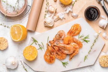 Plate with tasty shrimps on light background