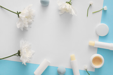 Composition with cosmetics and spring flowers on color background