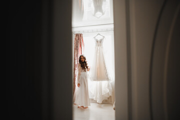 Luxury bride in white dress posing while preparing for the wedding ceremony