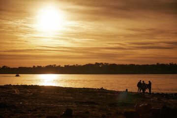 Fototapeta na wymiar fishermen at sunset, evening, scenic view