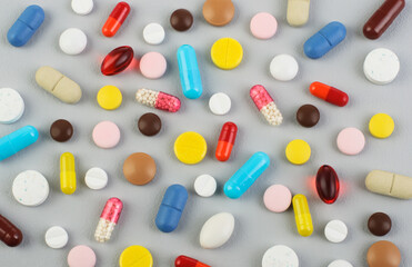 A photo of different medicinal drugs, tablets and pills on gray background, COVID-19; Coronavirus; Treatment; Virus