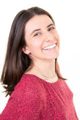 portrait of a young happy brunette woman smiling on white background