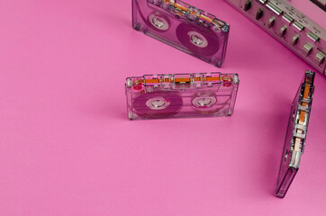 Boom box Stereo Radio Cassette Recorder and random cassettes on pink background.