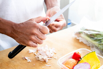Men peeling garlic